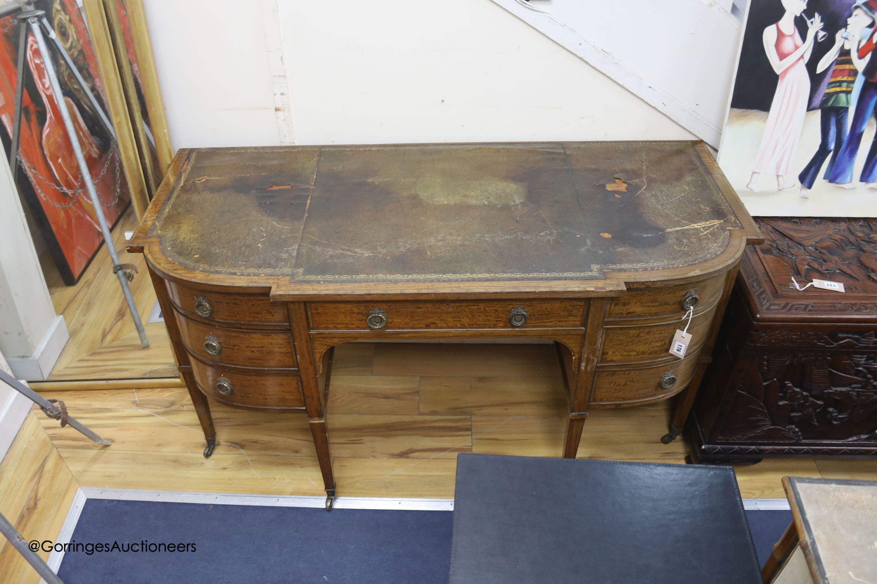 An Edwardian banded breakfront kneehole desk, length 142cm, depth 63cm, height 75cm